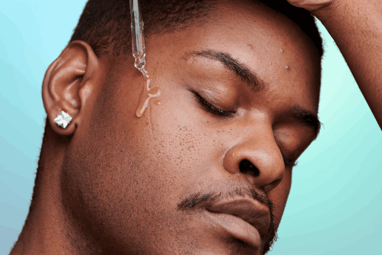 Man applying serum to face